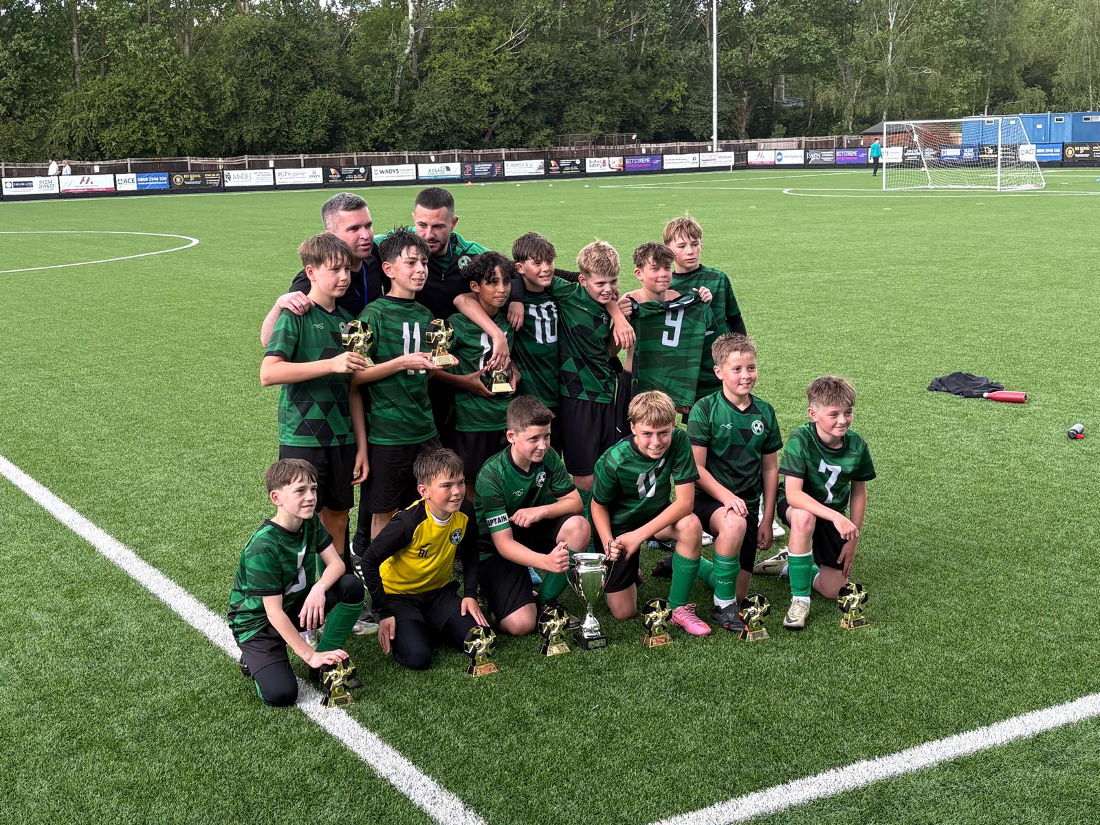 Linslade Galaxy team and coaches with trophies